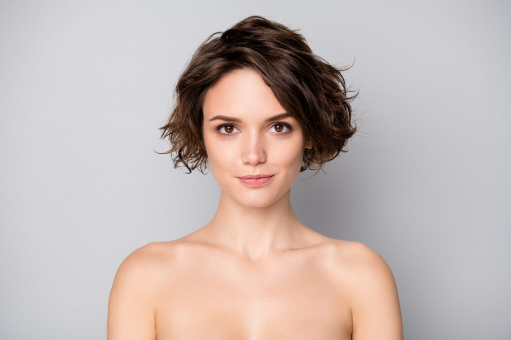 Portrait of minded pensive gorgeous girl look in mirror enjoy plastic surgery, treatment isolated over gray color background